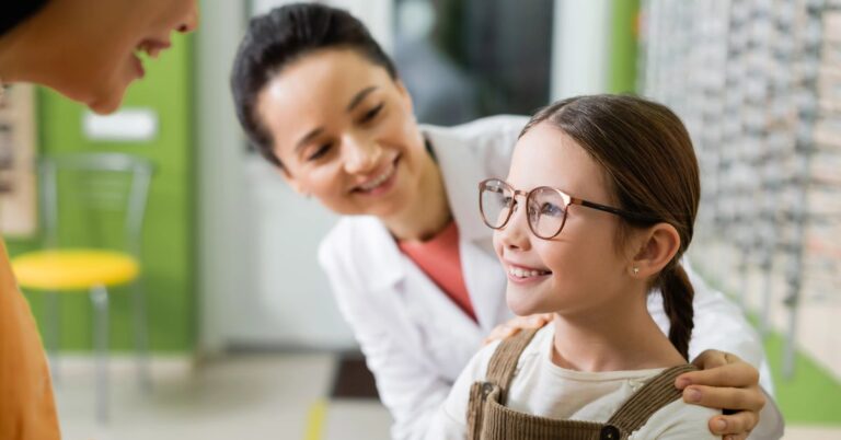 Optometirst discussing myopia management with parent and child