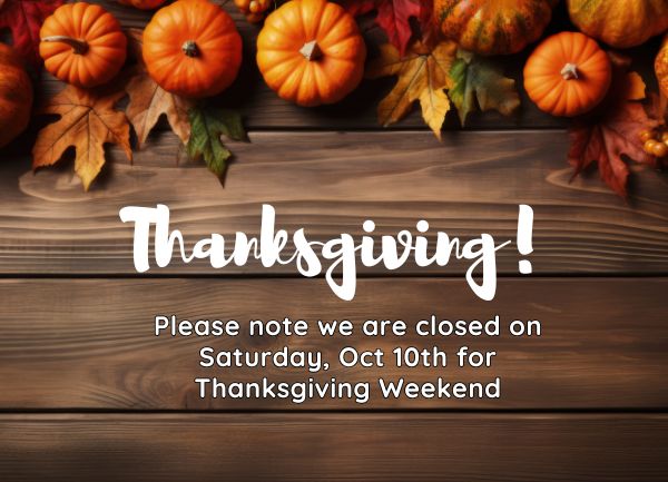 Thanksgiving closure notice stating the business is closed on Saturday, October 10th for Thanksgiving weekend, decorated with pumpkins and autumn leaves on a wooden background.